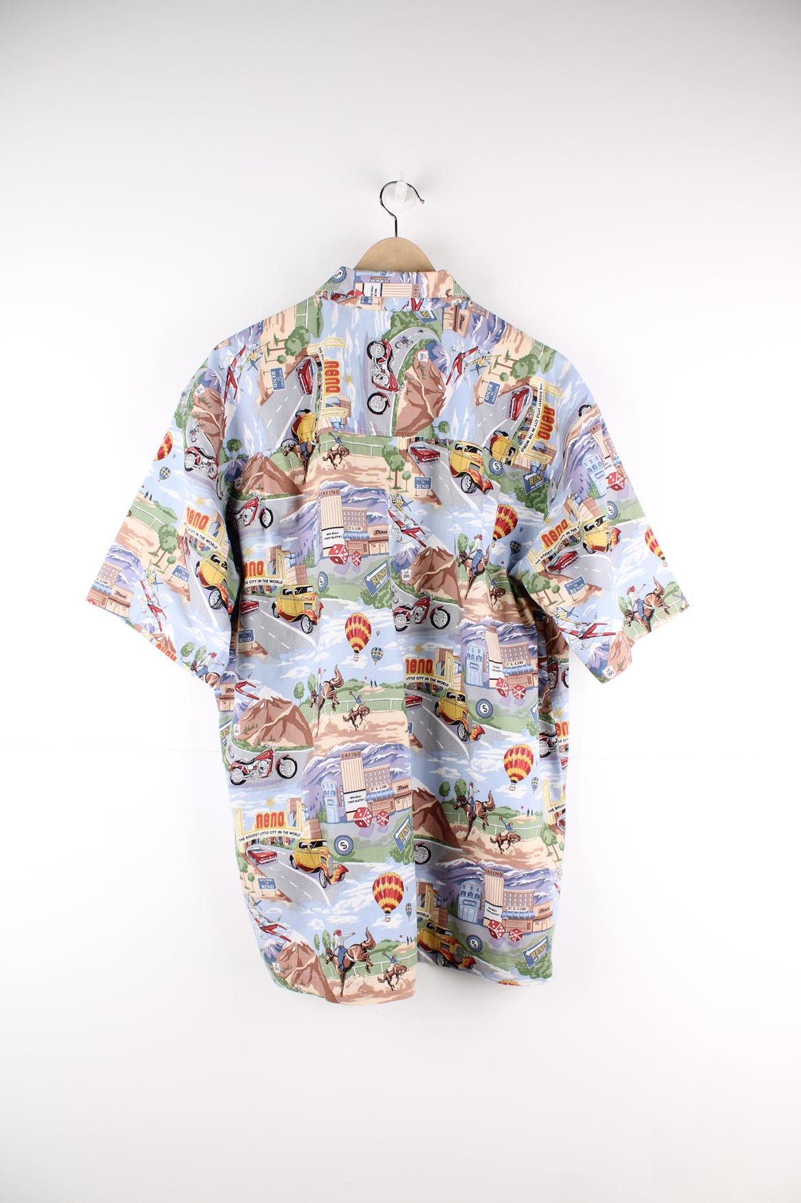 Vintage Dem Crazy Hawaiian Shirt in a blue colourway with gambling and rodeo style design printed all over, button up and has a chest pocket.