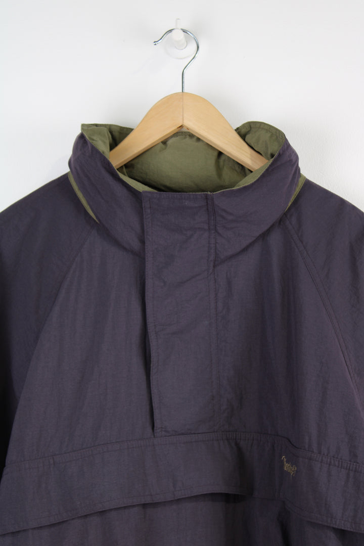 Vintage Timberland pullover jacket in a purple colourway, half zip, multiple pockets, hidden hood and has the logo embroidered on the front and back of the collar.