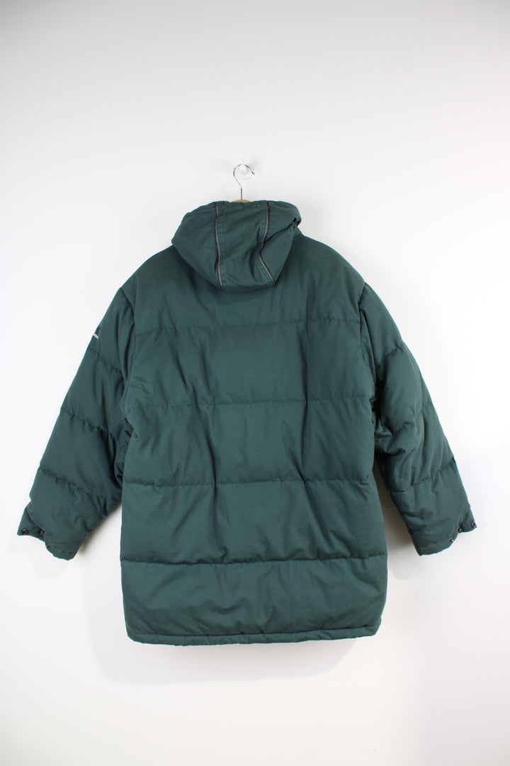 Helly Hansen Down Puffer Jacket in a dark green colourway, zip up, multiple pockets, insulated, hooded and has the logo embroidered on the chest. 