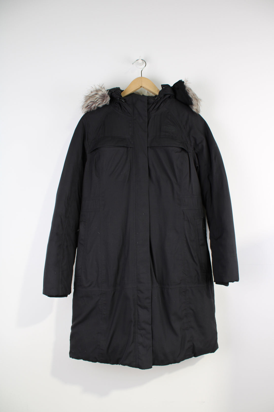 The North Face Parka Jacket in a black colourway, insulated with a quilted lining, zip up, multiple pockets, hooded with detachable fur option, and has logo embroidered on the front. 