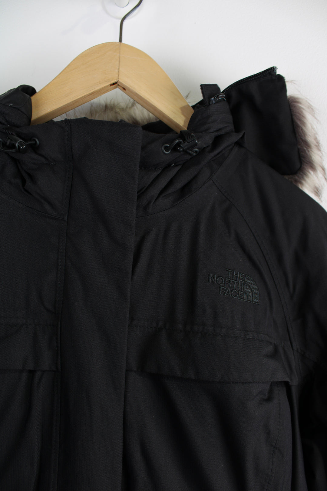 The North Face Parka Jacket in a black colourway, insulated with a quilted lining, zip up, multiple pockets, hooded with detachable fur option, and has logo embroidered on the front. 