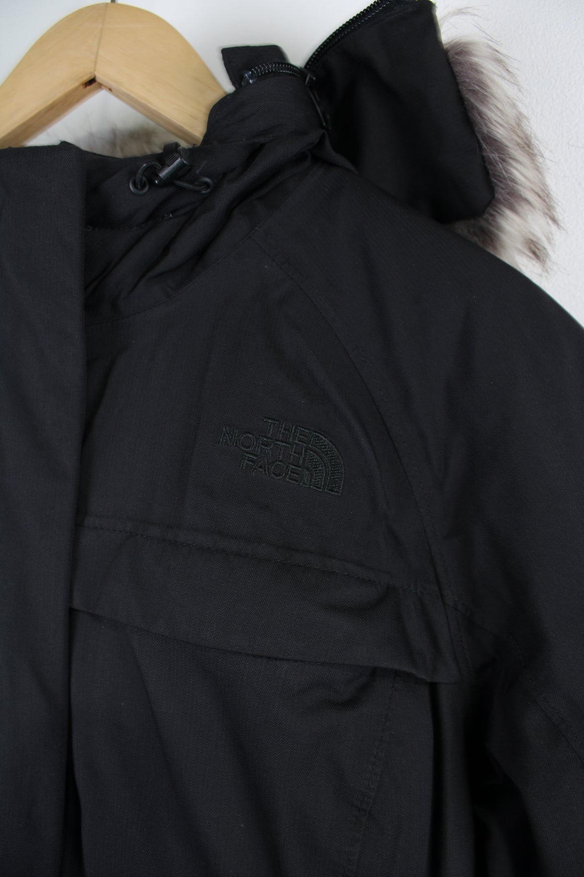 The North Face Parka Jacket in a black colourway, insulated with a quilted lining, zip up, multiple pockets, hooded with detachable fur option, and has logo embroidered on the front. 