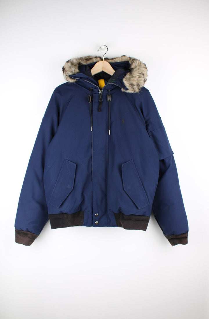 Navy blue Ralph Lauren parker style bomber jacket. Features down feather lining, detachable faux fur trim on the hood and has elasticated cuffs/ hem. Closes with a zip and buttons. good condition - faux fur trim is slightly matted (see photos) Size in Label: Mens S