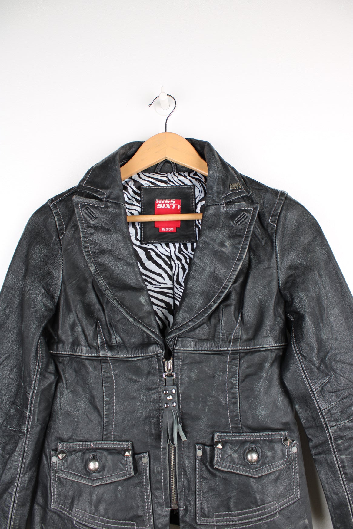 Vintage Y2K Miss Sixty leather jacket. Black blazer style jacket with silver stud detail on the zip pull and pockets. Features metal Miss Sixty logo on the lapel  Good condition - some scuffs and scratches to the leather giving it a slightly distressed look.  Size in Label  Womens M - Measures more like a S