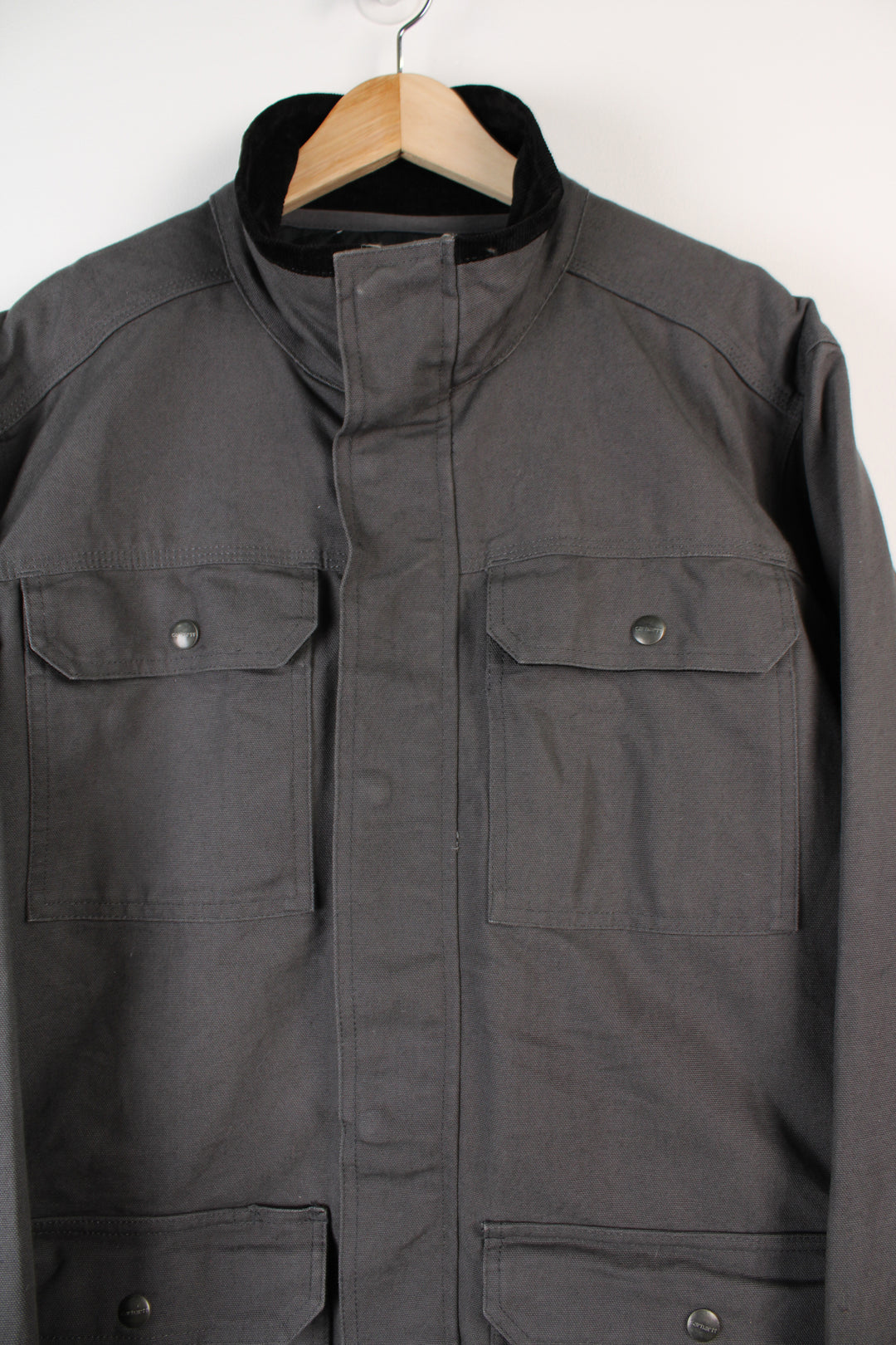 Grey Carhartt workwear jacket with corduroy collar, multiple pockets and removable quilted liner