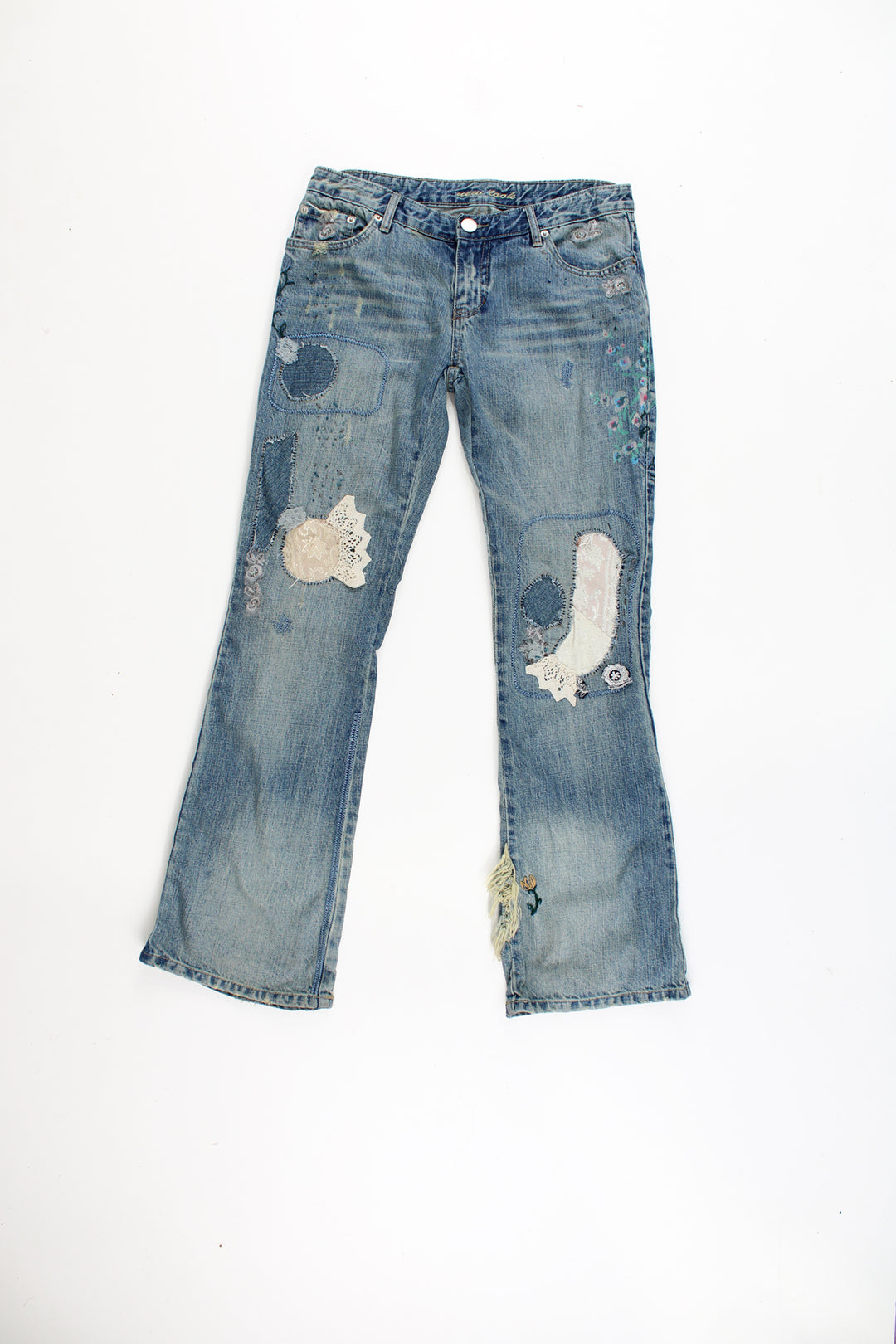 New Look low rise distressed jeans with multiple pockets, and has embroidered patterns and distressed style throughout the jeans.