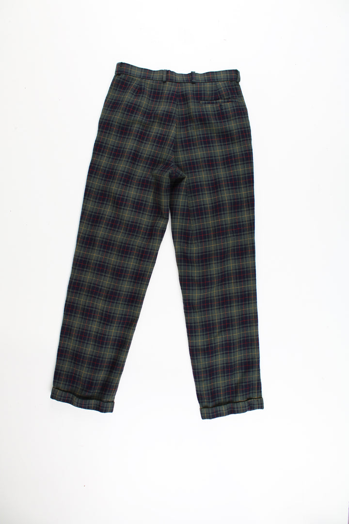 Lacoste plaid trousers in a green, blue, red and yellow colourway, multiple pockets, cuffed at the bottom and has the logo embroidered on the front.