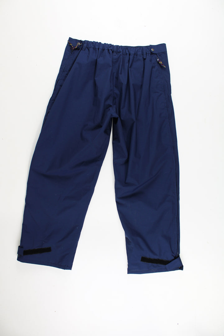 Helly Hansen Walking Trousers in a blue colourway, zip down the side of the legs and has the logo embroidered on the front.