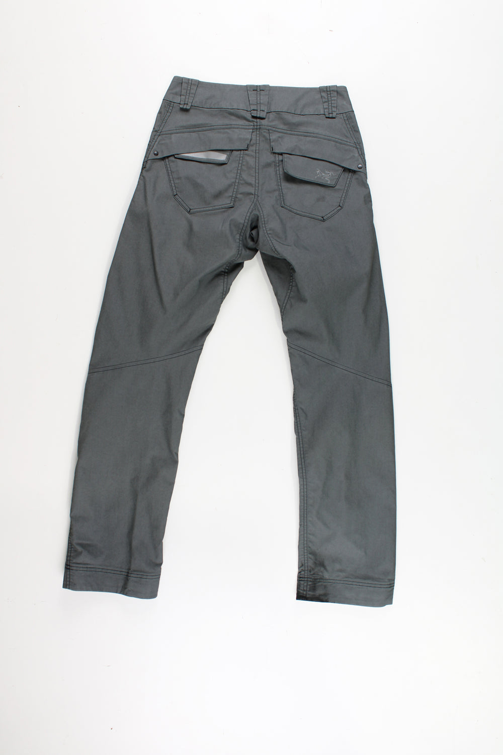 Arcteryx grey slim leg tech trousers with multiple pockets and reflective accents 