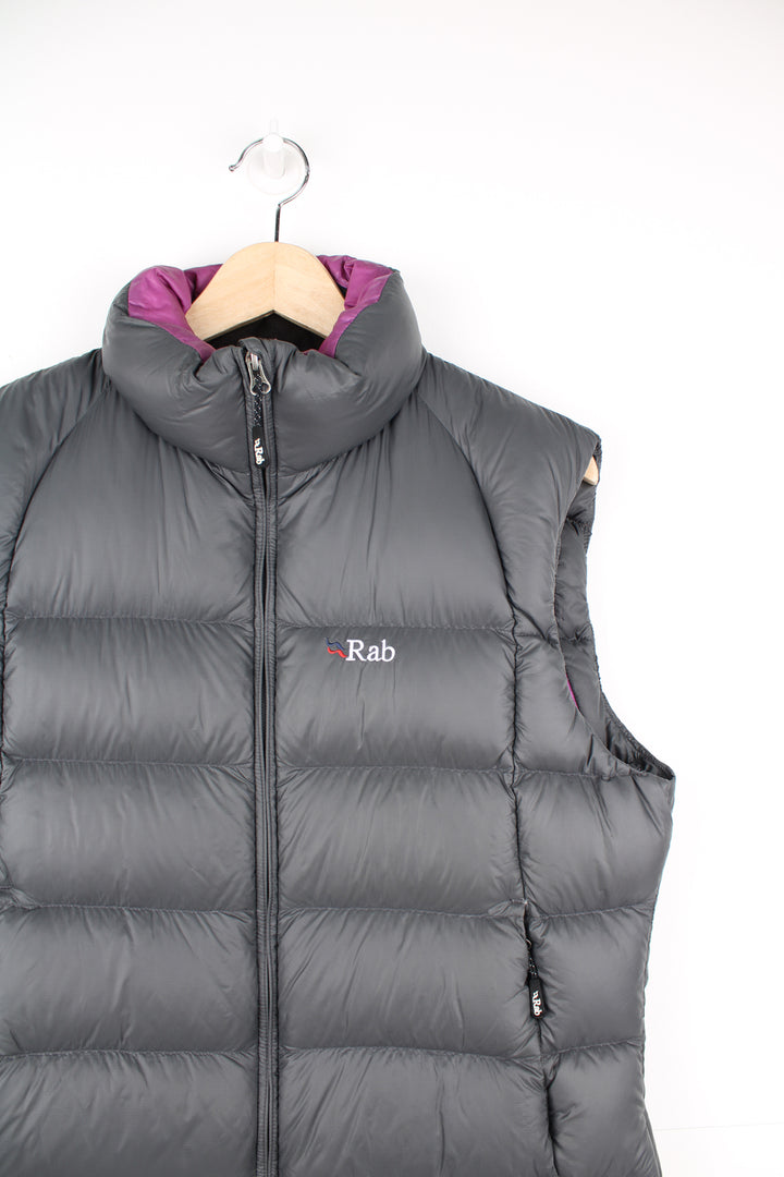 Rab Gilet in a grey and purple colourway, zip up, side pockets, insulated lining, and has the logo embroidered on the front.