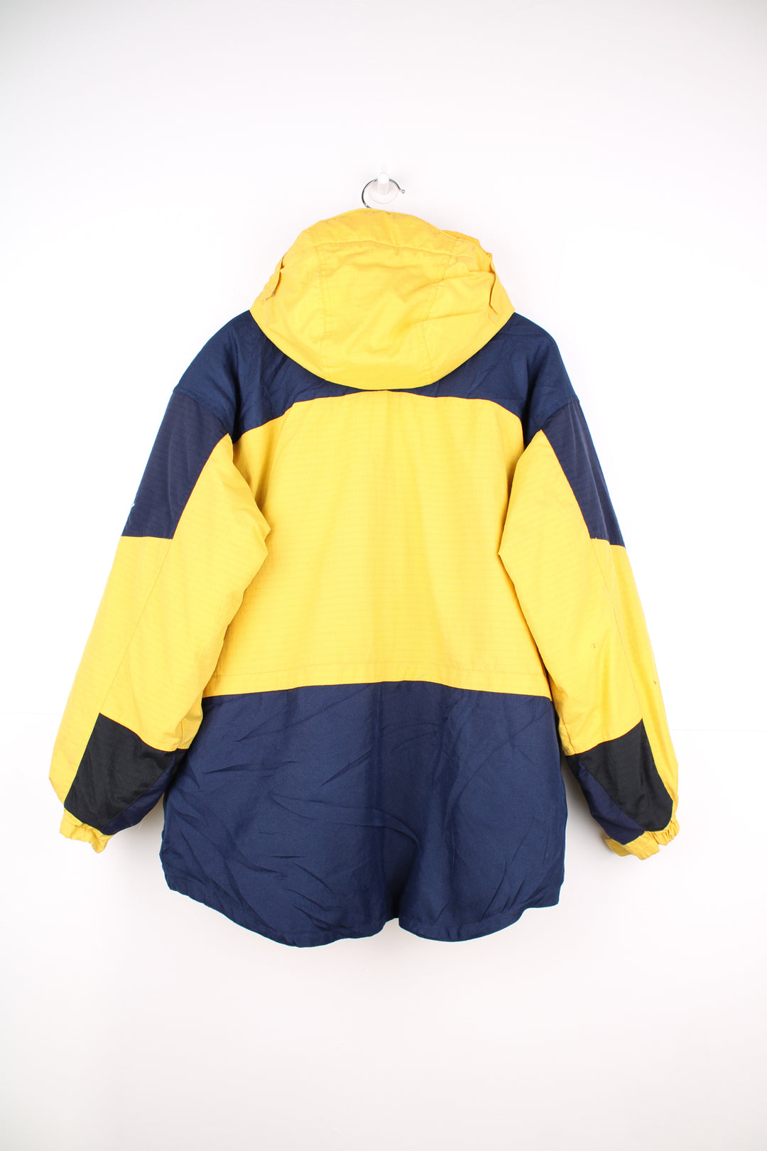 Columbia Tectonite Jacket in a yellow and navy blue colourway, zip up, multiple pockets, insulated lining, hooded and has the logo embroidered on the front.