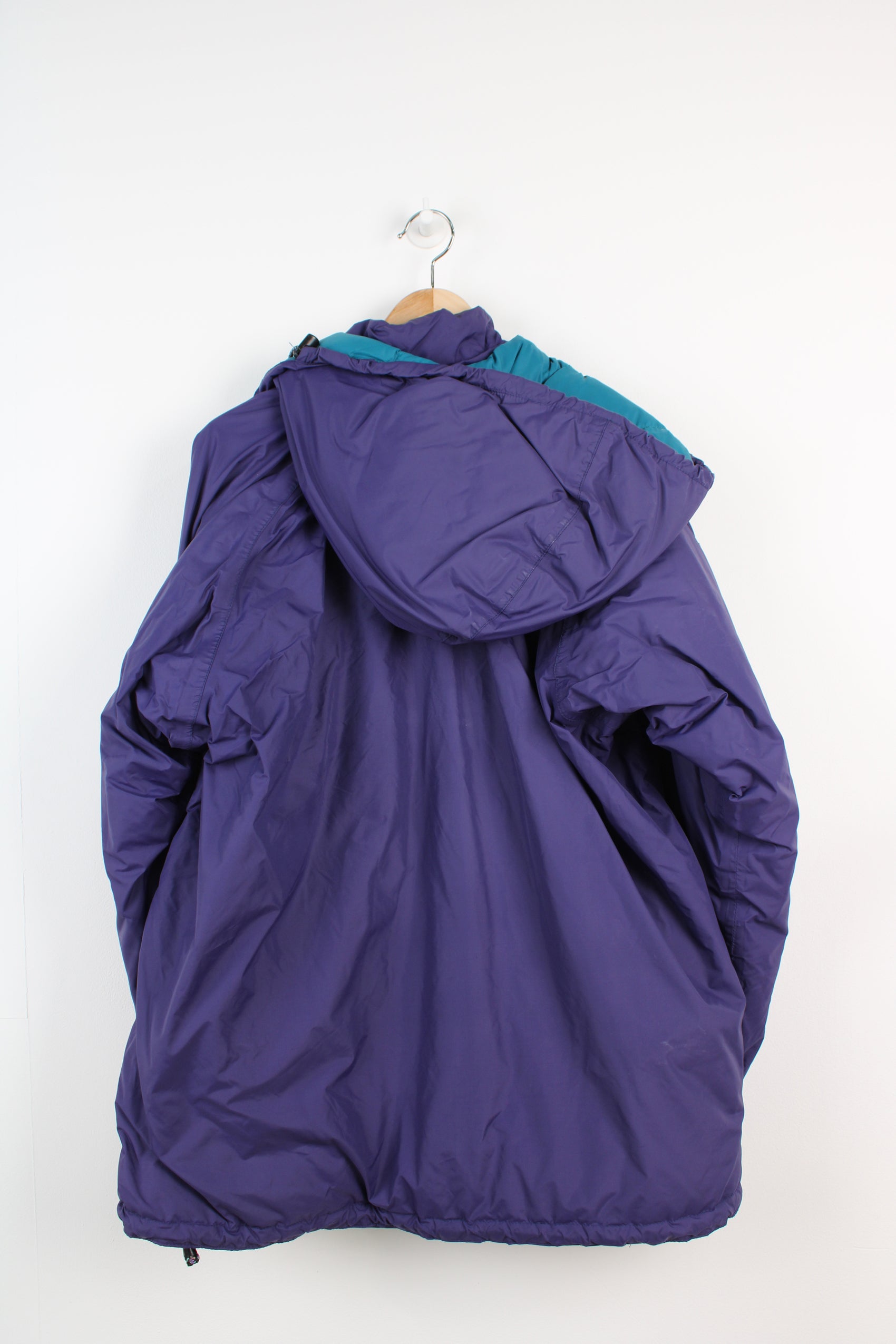 Mountain Equipment Made in the UK purple puffer jacket with and logo on front and removable hood