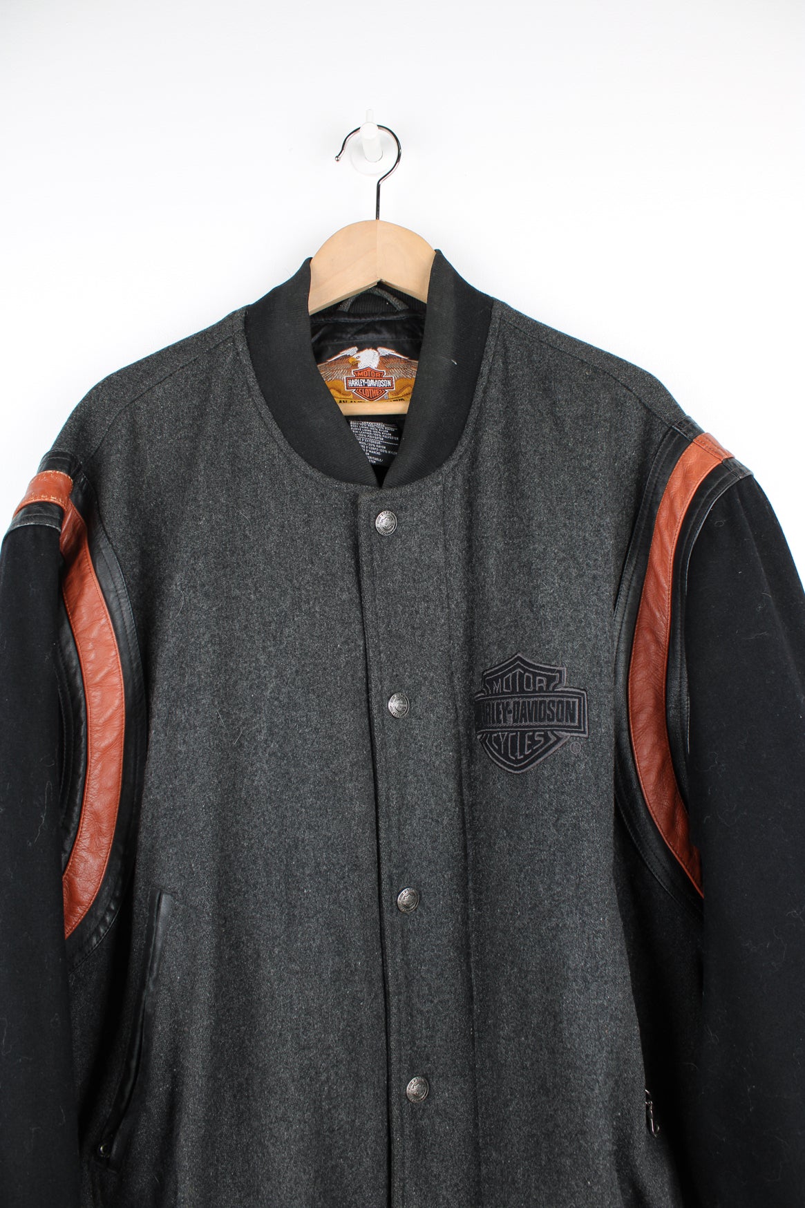 Vintage Harley Davidson varsity style wool bomber jacket. Features a grey wool body with black wool arms and leather trim around the arms. Has embroidered logo on the chest and back.   good condition  Size in Label:  Mens XL - Measures more like a XXL