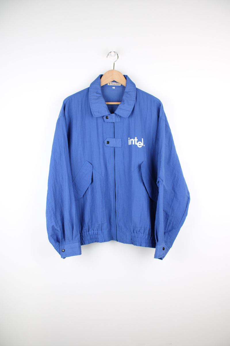 Vintage 90's blue Windbreaker/ bomber jacket with printed "Intel" logo on the chest and back. Closes with a zip and popper buttons. good condition Size in Label: Mens XXL - Measures more like a mens XL