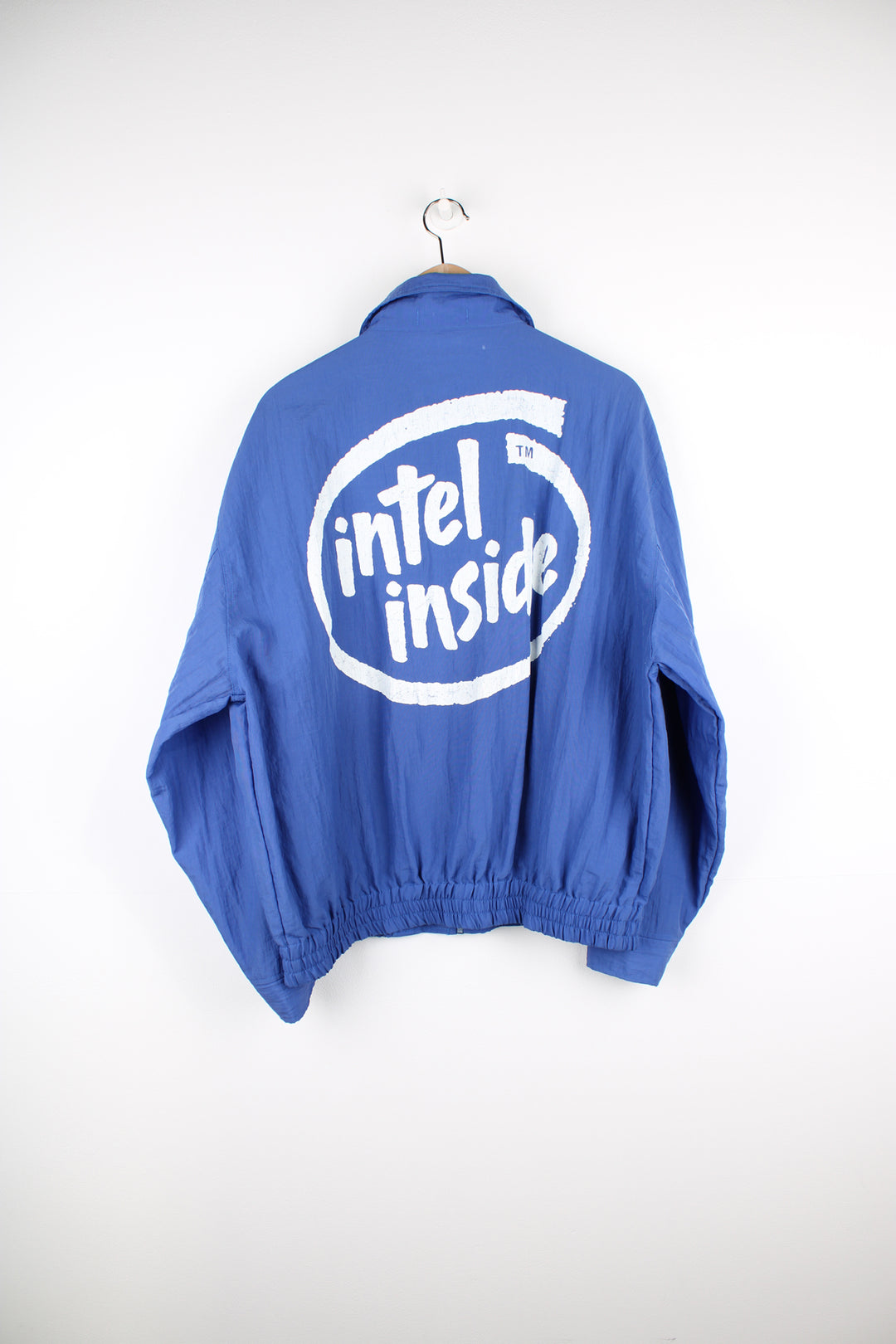 Vintage 90's blue Windbreaker/ bomber jacket with printed "Intel" logo on the chest and back. Closes with a zip and popper buttons. good condition Size in Label: Mens XXL - Measures more like a mens XL