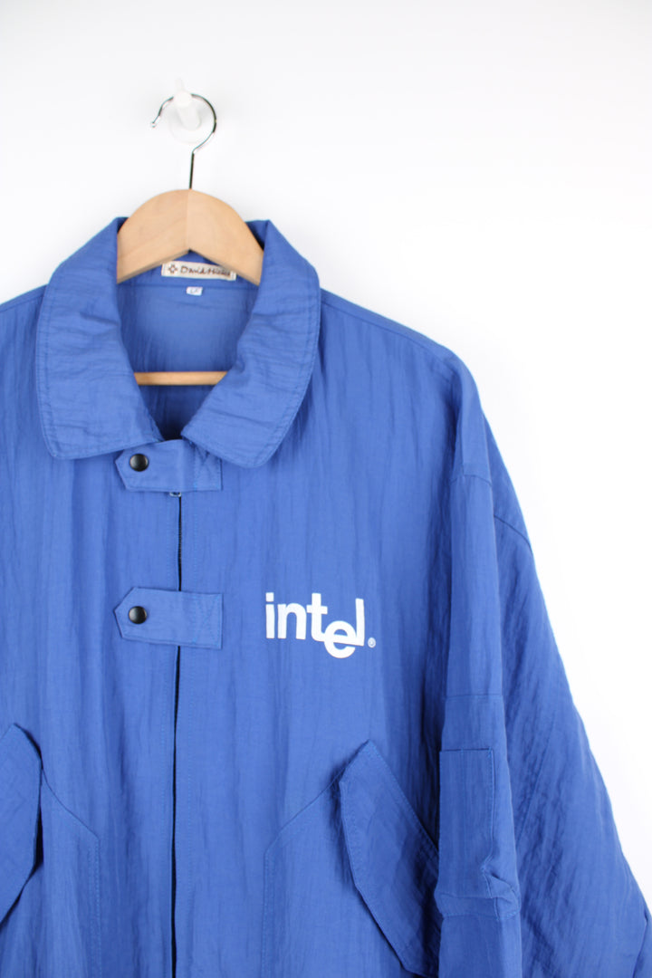 Vintage 90's blue Windbreaker/ bomber jacket with printed "Intel" logo on the chest and back. Closes with a zip and popper buttons. good condition Size in Label: Mens XXL - Measures more like a mens XL