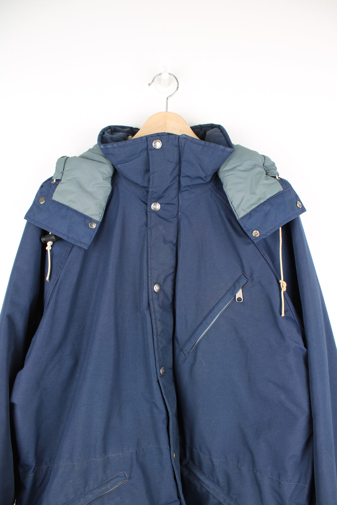 The North Face Goretex Jacket in a blue colourway, parka style, zip up, multiple pockets, hooded and has a insulated lining.