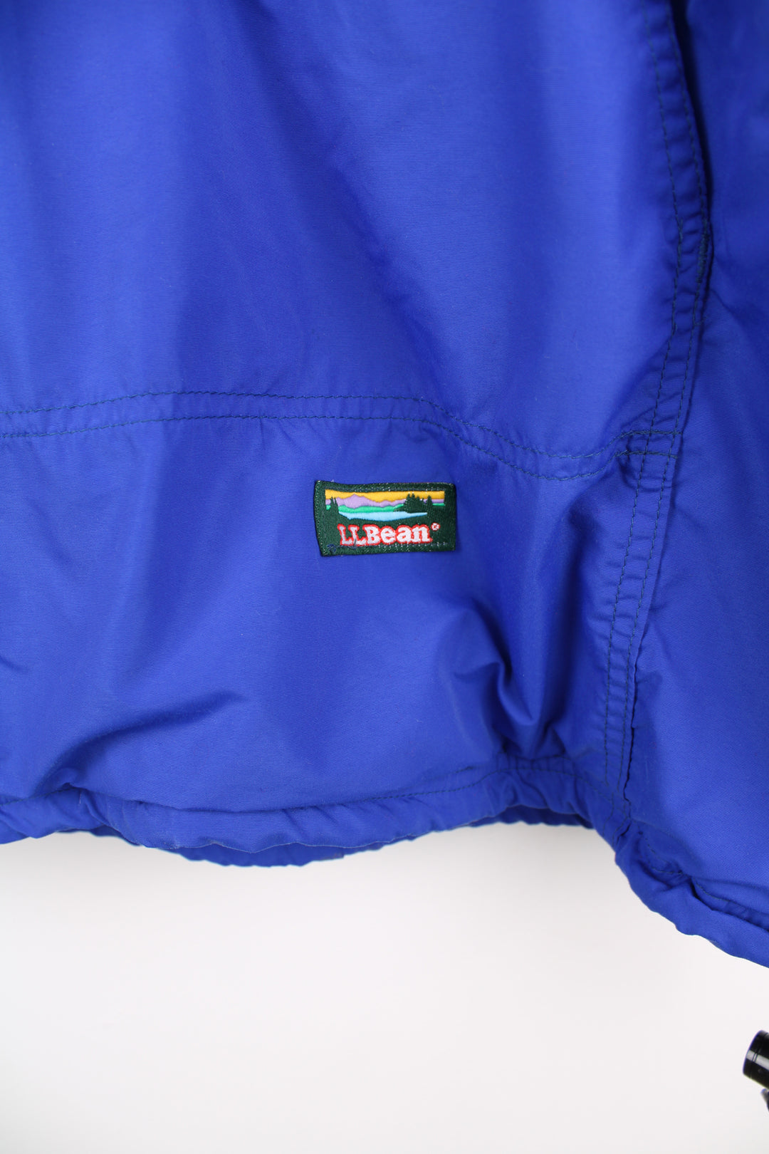 L.L. Bean Anorak Jacket in a blue colourway, half zip, big pouch pockets, fleece lining, hooded, and has the logo embroidered on the front.