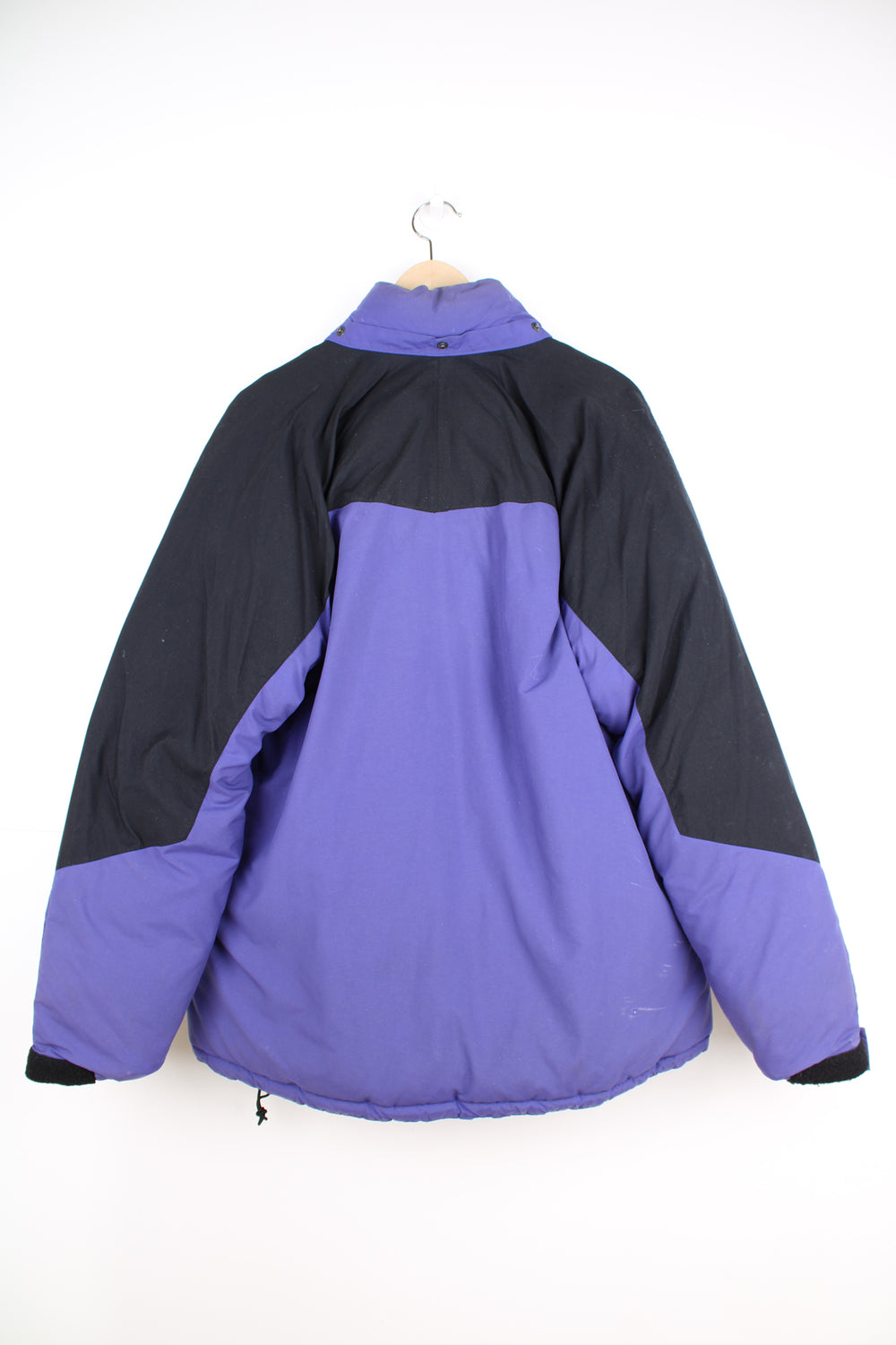 Mountain Equipment Jacket in a purple and black colourway, zip up, side pockets, and has the logo embroidered on the front.