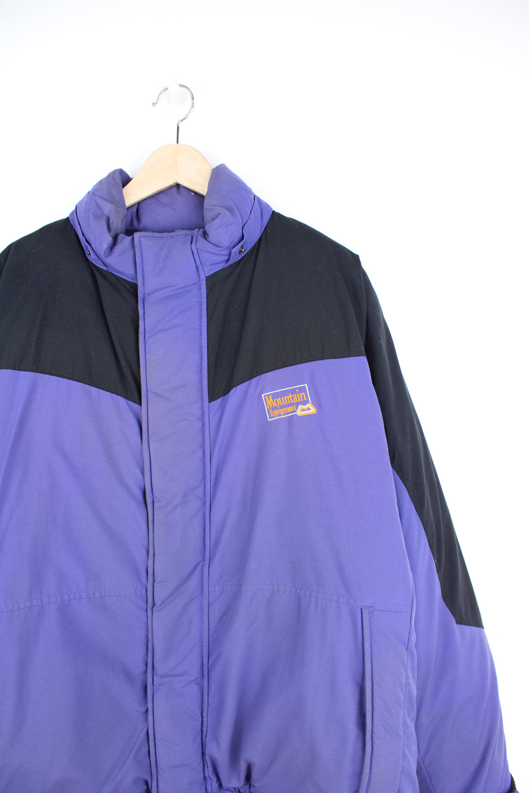 Mountain Equipment Jacket in a purple and black colourway, zip up, side pockets, and has the logo embroidered on the front.