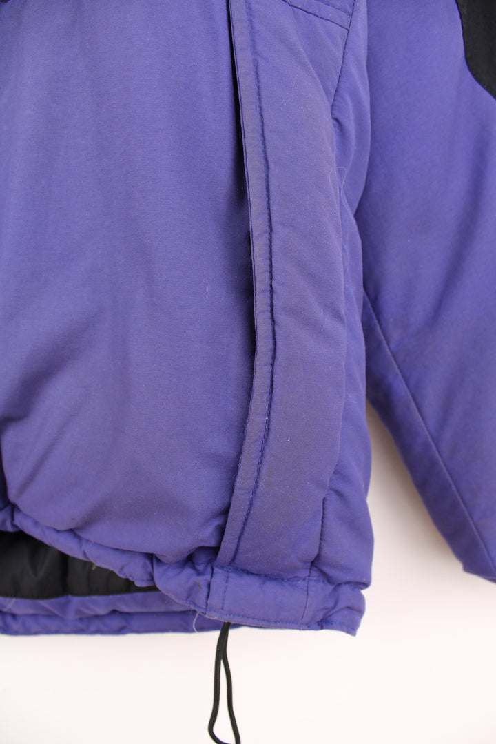 Mountain Equipment Jacket in a purple and black colourway, zip up, side pockets, and has the logo embroidered on the front.