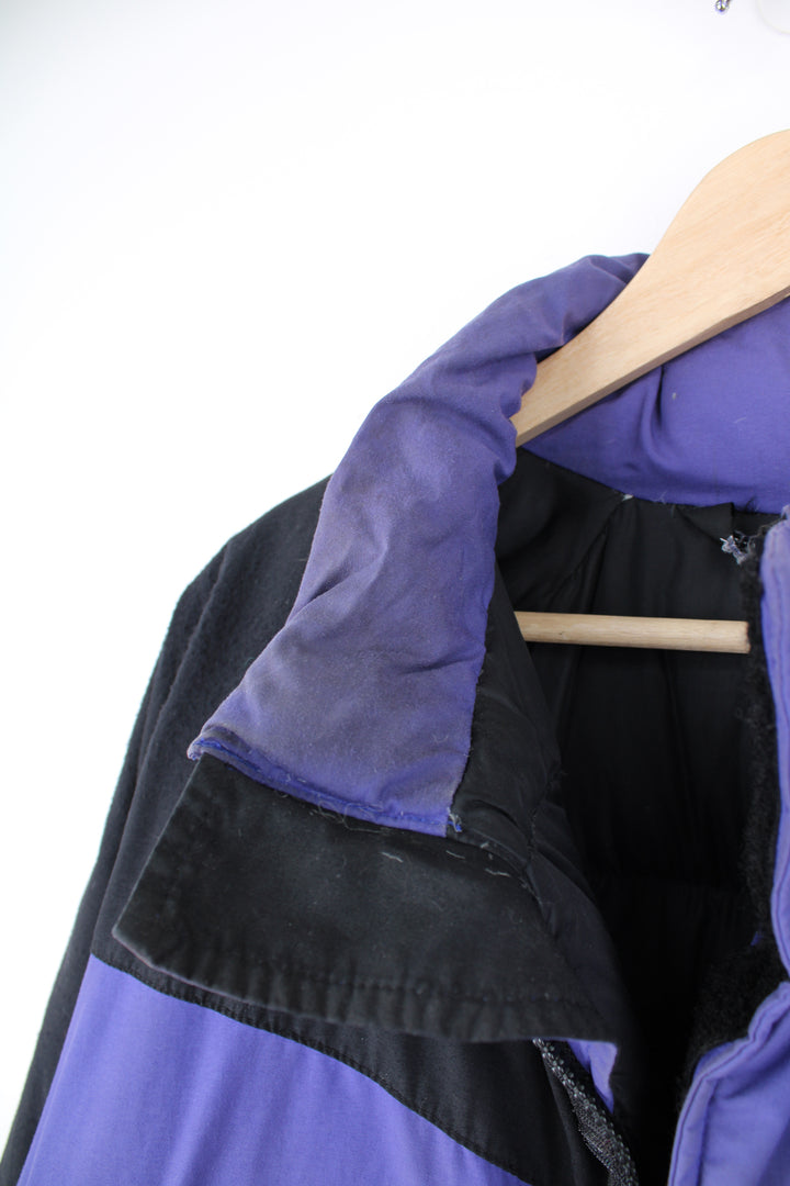 Mountain Equipment Jacket in a purple and black colourway, zip up, side pockets, and has the logo embroidered on the front.