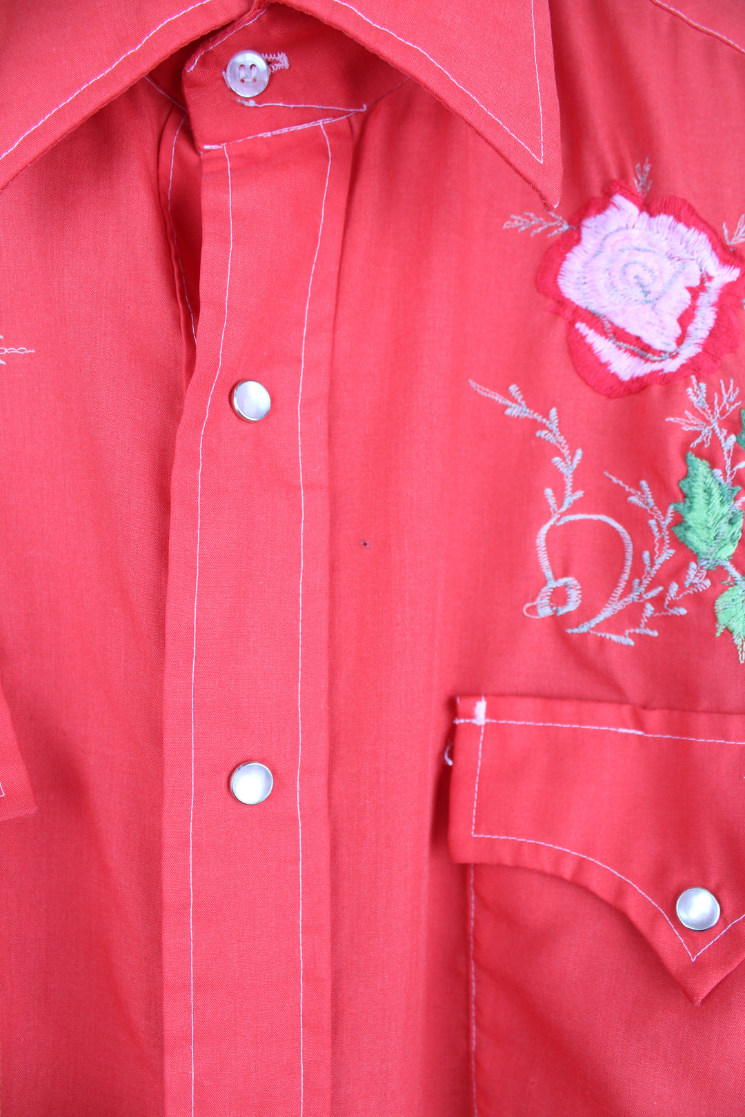 Vintage 70's/80's Champion Westerns all red western shirt, features embroidered roses , pearl snap buttons and yoke on the front and back 