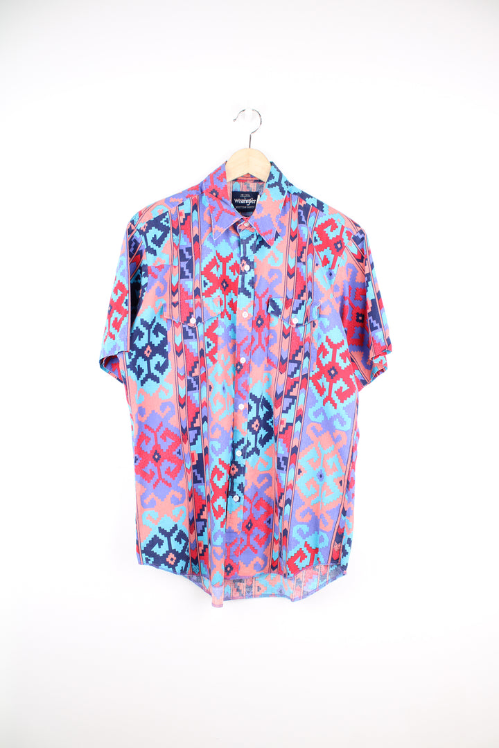 Vintage Wrangler short sleeved button up shirt in purple/coral features all over western style print and yoke on the front and back