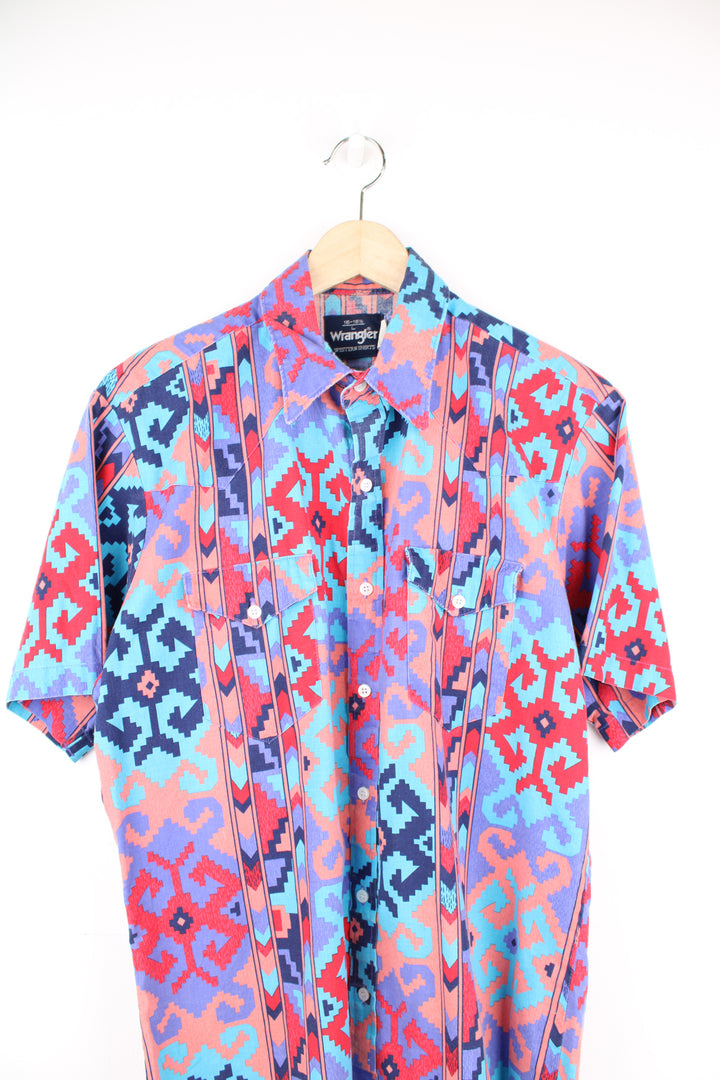 Vintage Wrangler short sleeved button up shirt in purple/coral features all over western style print and yoke on the front and back