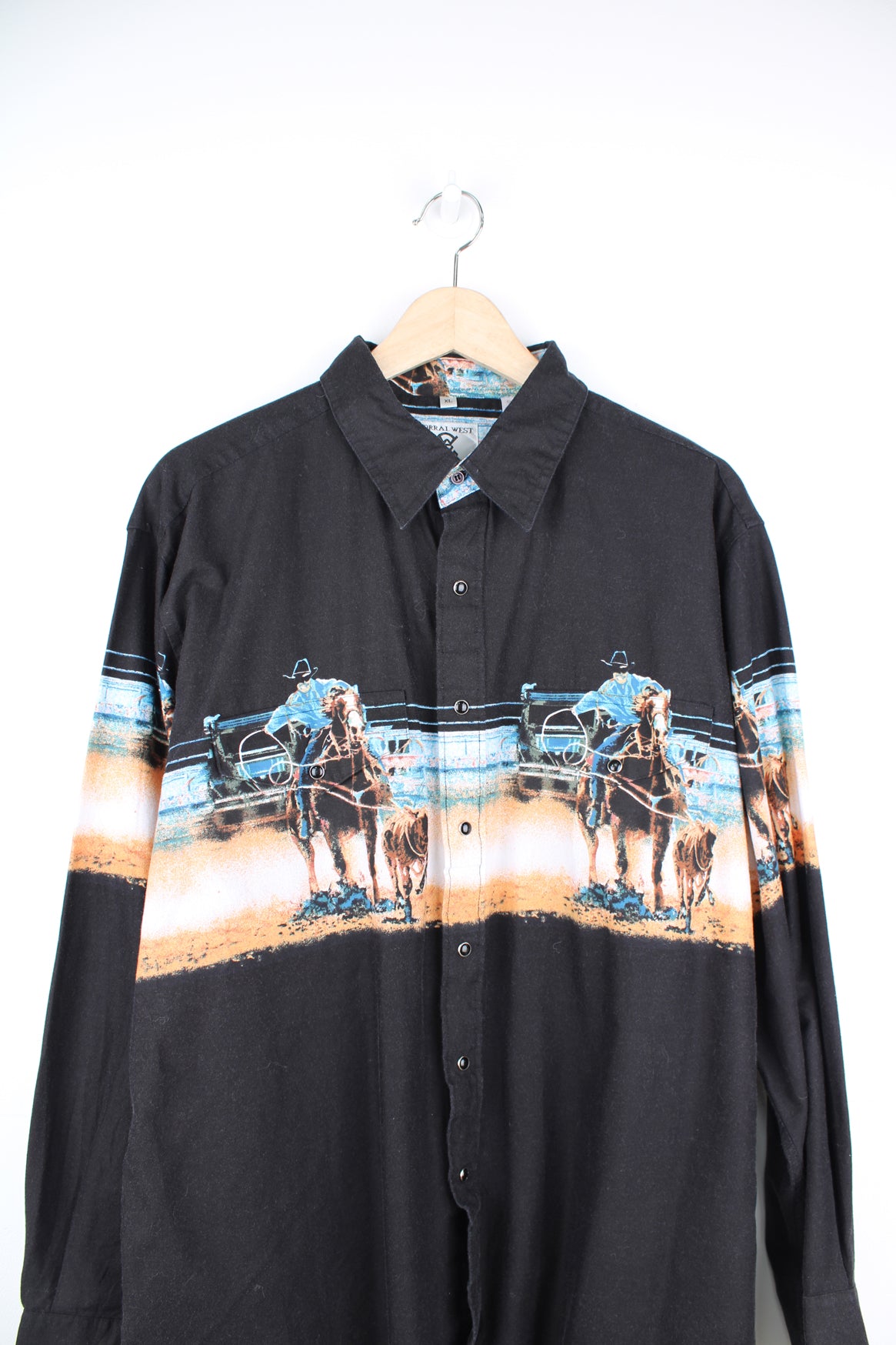 Vintage Corral West western shirt, features all over graphic of cowboys herding cattle , a western style yoke and snap buttons 