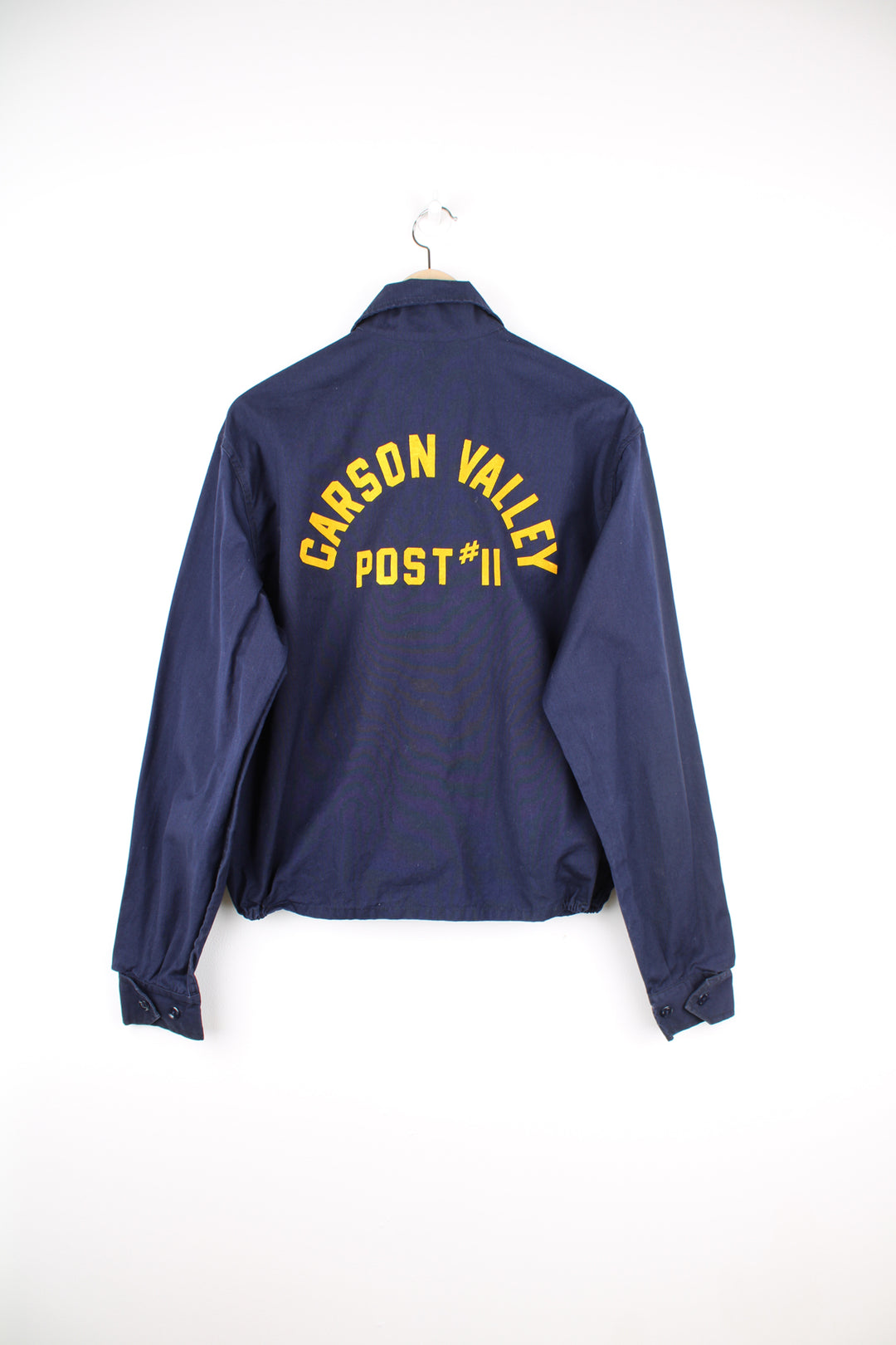 Vintage looks like 70's navy blue zip through American Legion cotton cropped bomber jacket with printed badge on the chest and spell-out 'Carson Valley Post #11' on the back