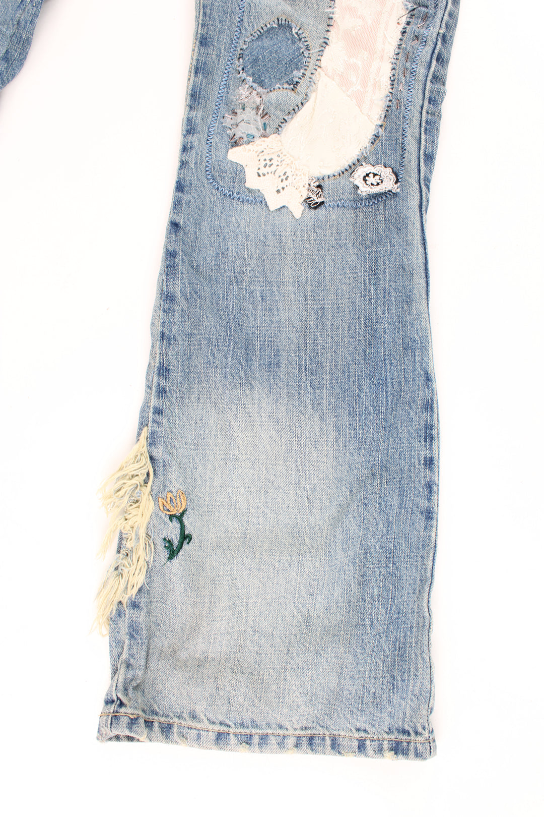 New Look low rise distressed jeans with multiple pockets, and has embroidered patterns and distressed style throughout the jeans.