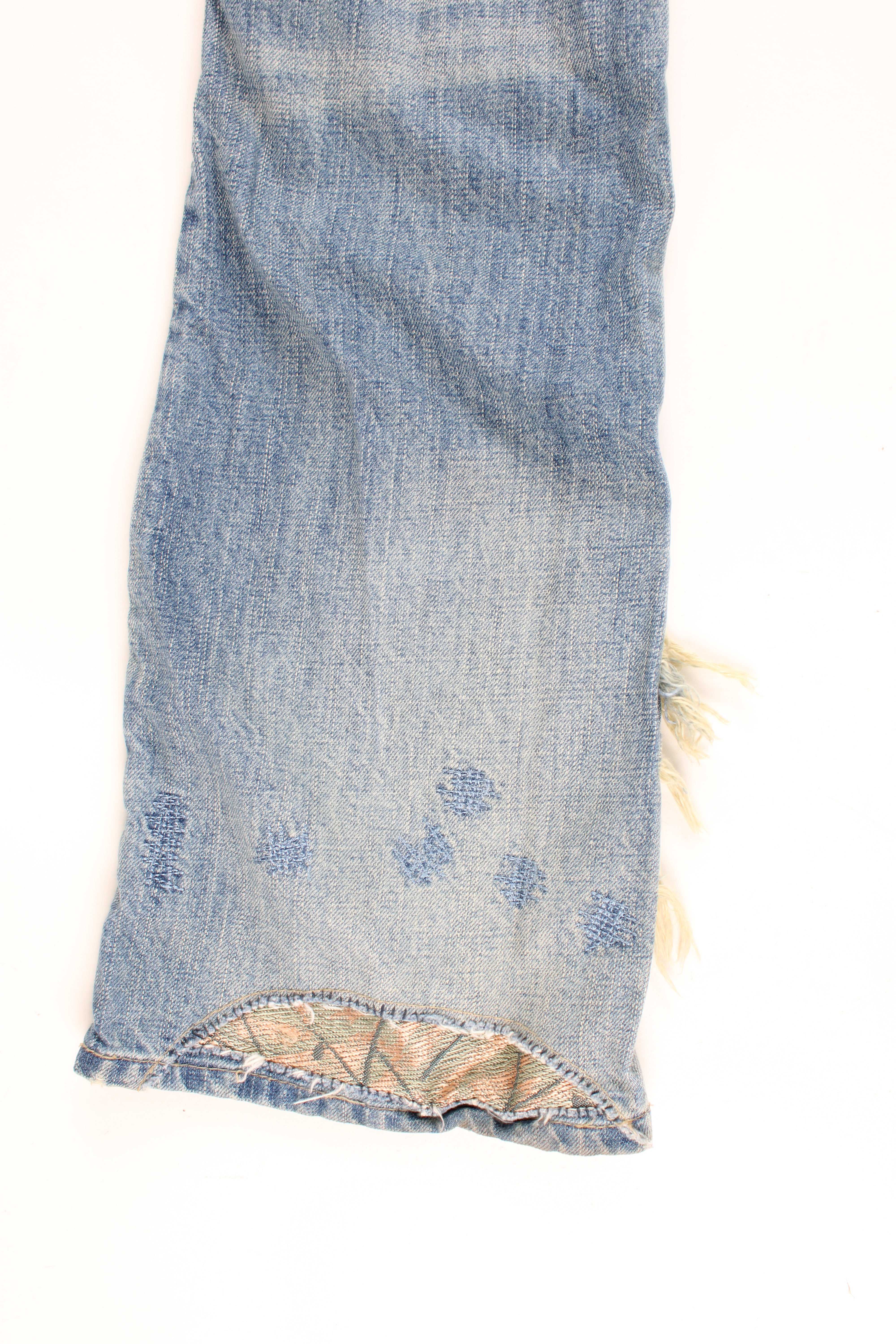 New Look low rise distressed jeans with multiple pockets, and has embroidered patterns and distressed style throughout the jeans.