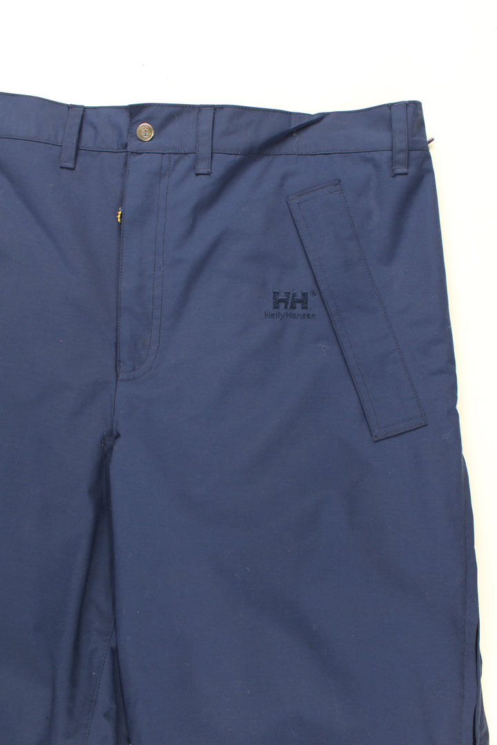 Helly Hansen Walking Trousers in a blue colourway, zip down the side of the legs and has the logo embroidered on the front.