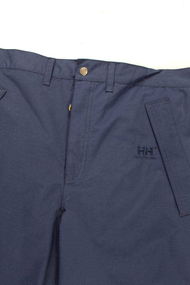 Helly Hansen Walking Trousers in a blue colourway, zip down the side of the legs and has the logo embroidered on the front.