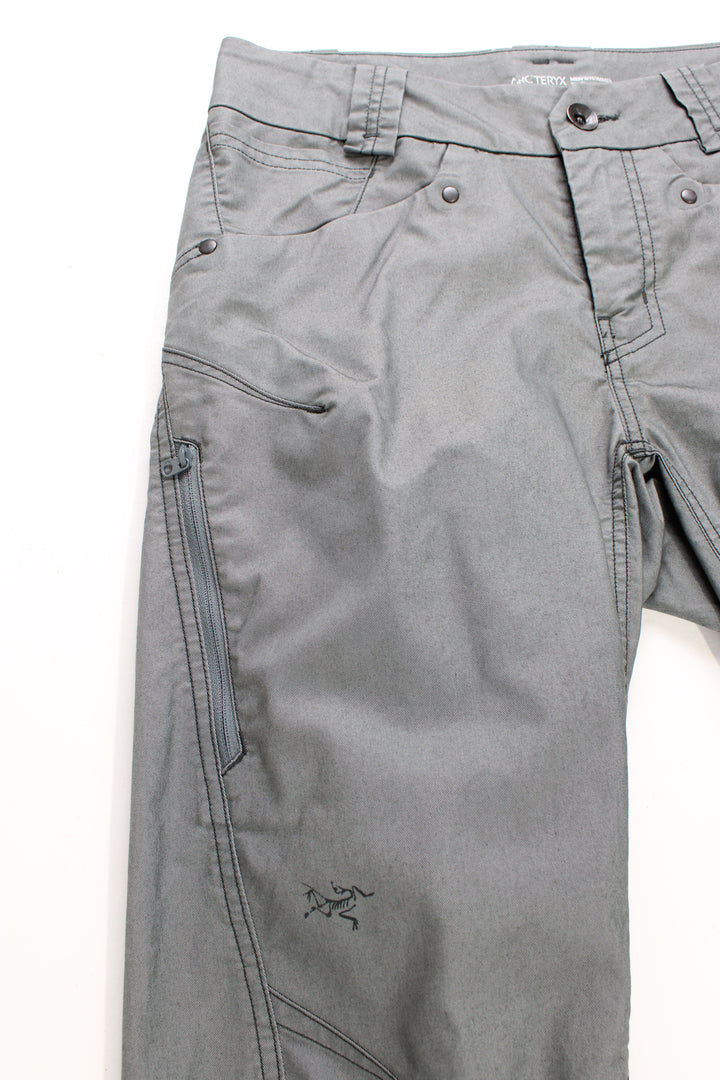 Arcteryx grey slim leg tech trousers with multiple pockets and reflective accents 