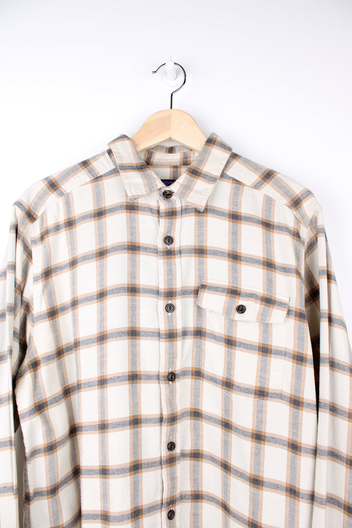 Patagonia Flannel Shirt in a tanned, blue and brown colourway, button up, chest pocket, and has the logo embroidered on the side.