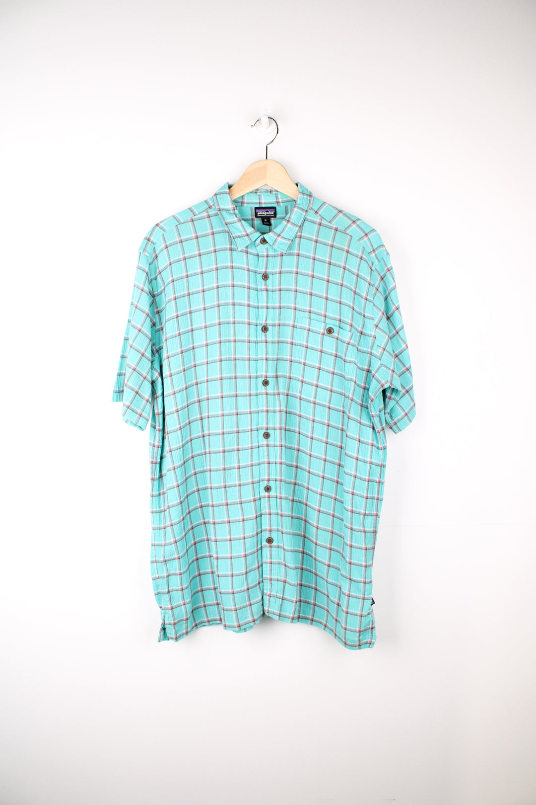 Patagonia Plaid Short Sleeve Shirt in a blue, red and white colourway, button up, chest pocket, and has the logo embroidered on the side.