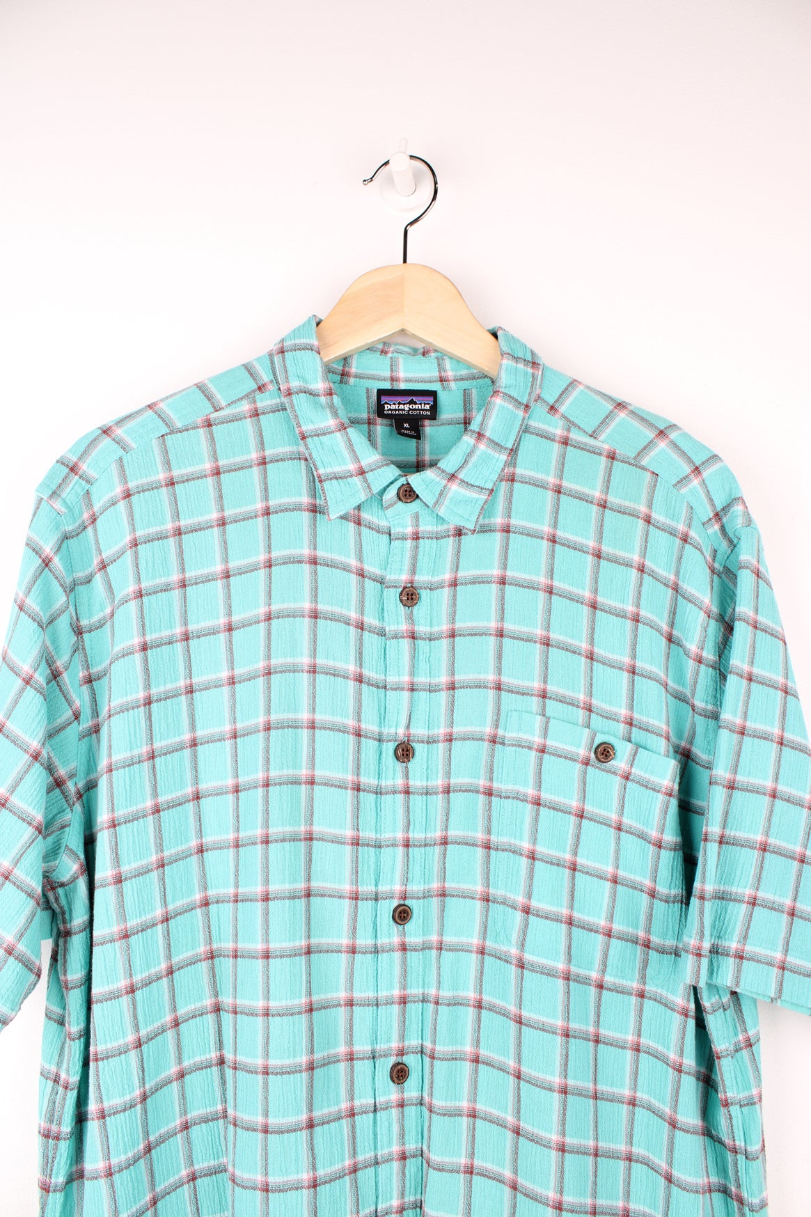 Patagonia Plaid Short Sleeve Shirt in a blue, red and white colourway, button up, chest pocket, and has the logo embroidered on the side.