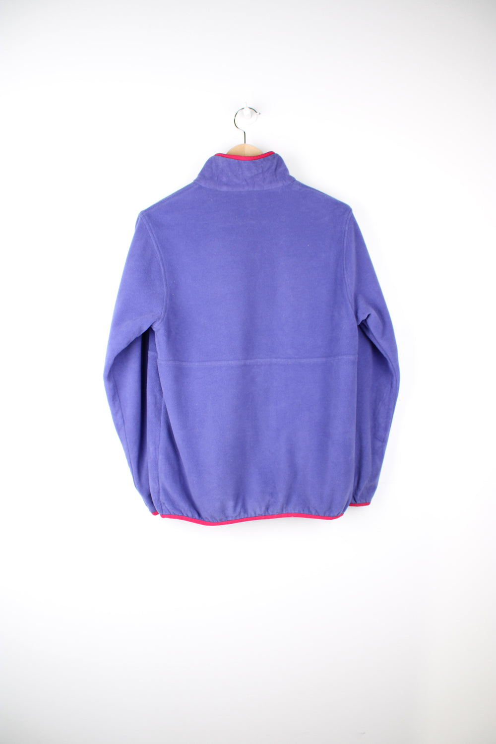 Patagonia Reversible Fleece in either a purple or pink colourway with a fleece or shell option, half zip, pockets and has the logo embroidered on the front.