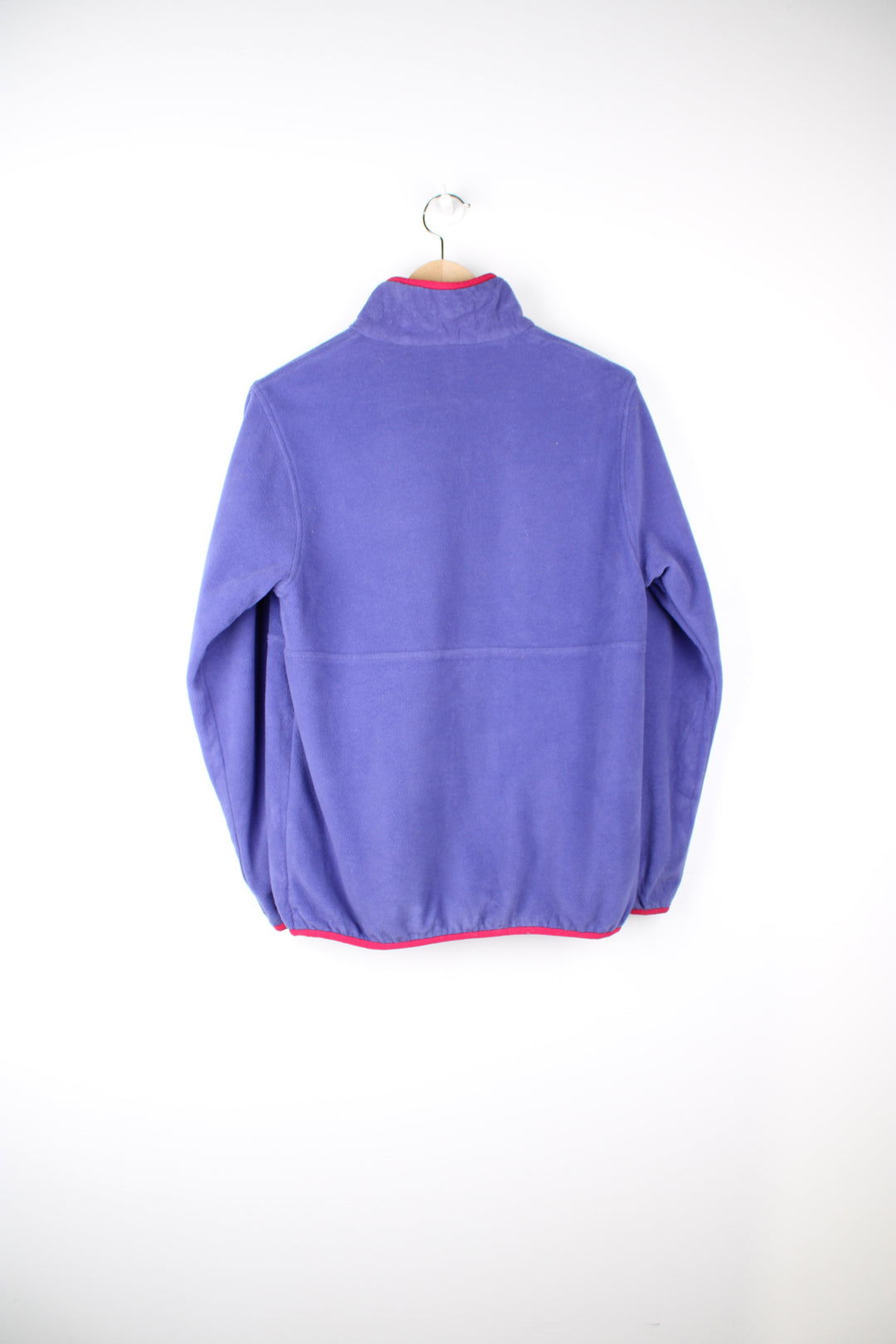 Patagonia Reversible Fleece in either a purple or pink colourway with a fleece or shell option, half zip, pockets and has the logo embroidered on the front.