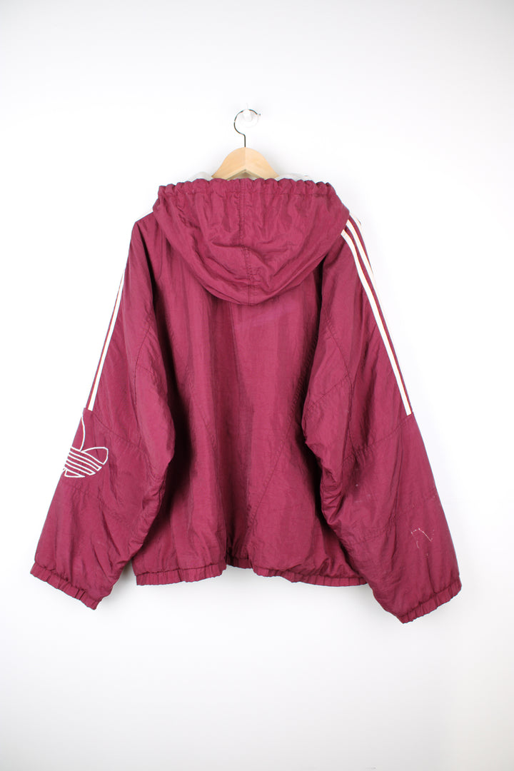 Vintage Adidas maroon red shell jacket with embroidered logo on the chest, embroidered three stripes down the arms and zip up pockets