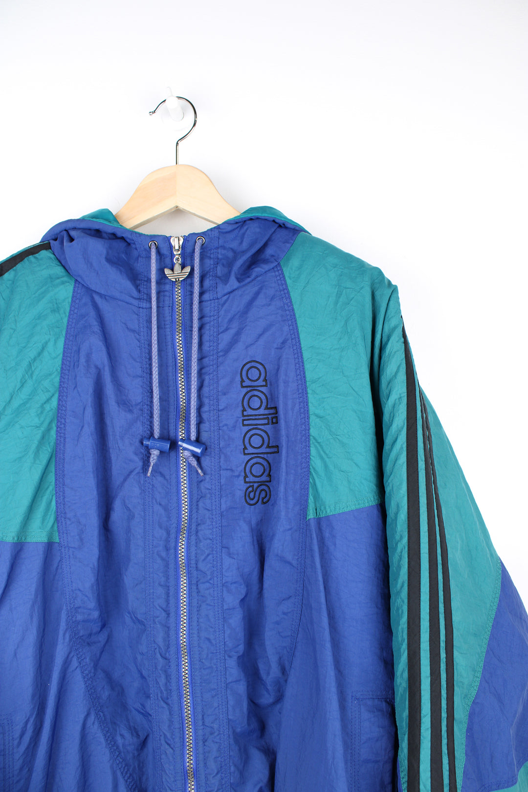 Vintage 90's blue and green Adidas bomber jacket, with embroidered logo on the chest and signature three stripes down the arms