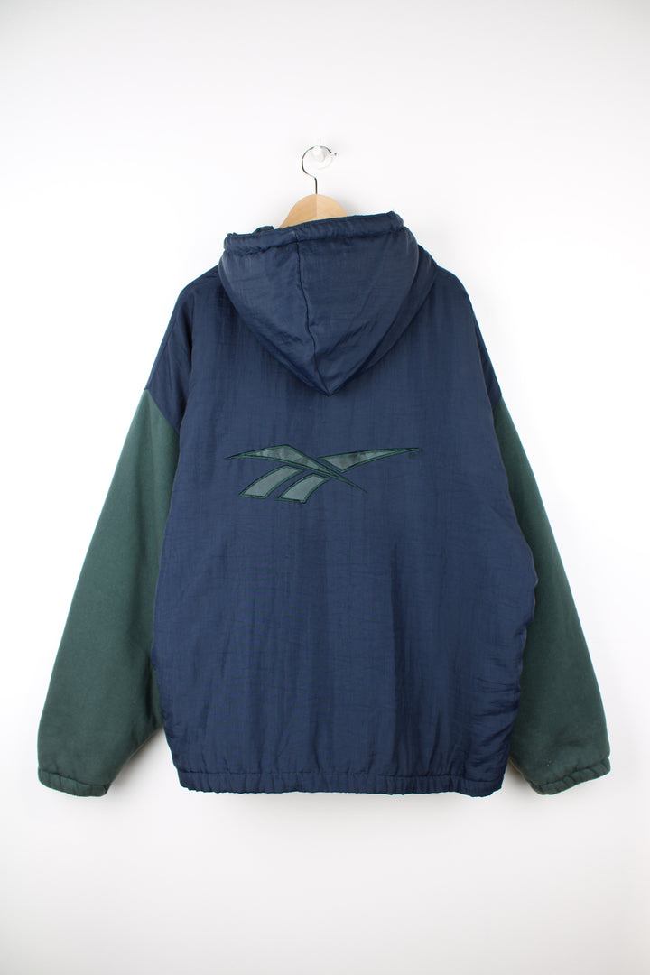 Vintage Reebok zip through hooded jacket in green and blue, features embroidered logo on the chest and back and cotton sleeves