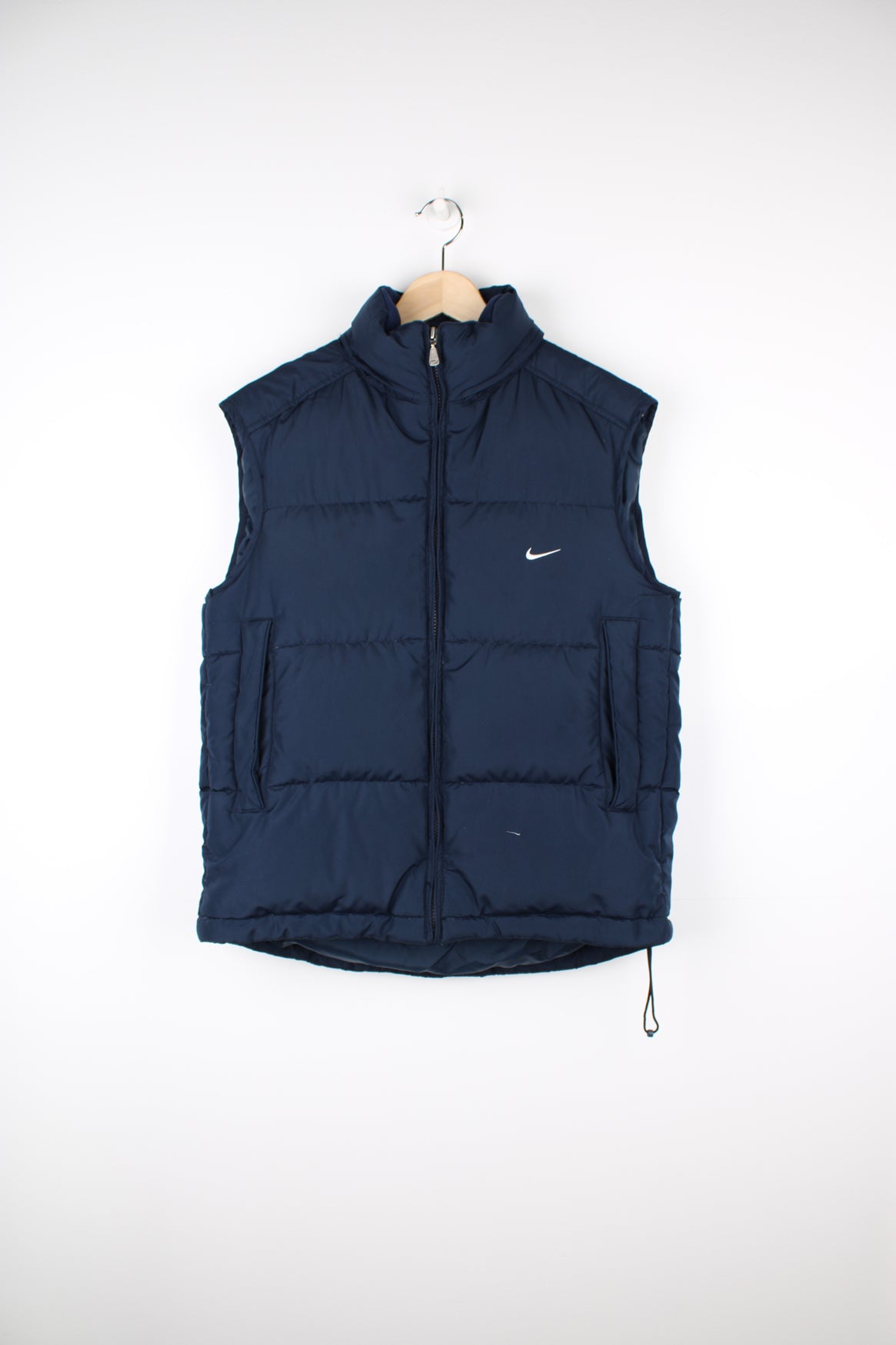 2000s navy blue Nike zip through puffer gilet, with swoosh embroidered logo on the front and foldaway hood