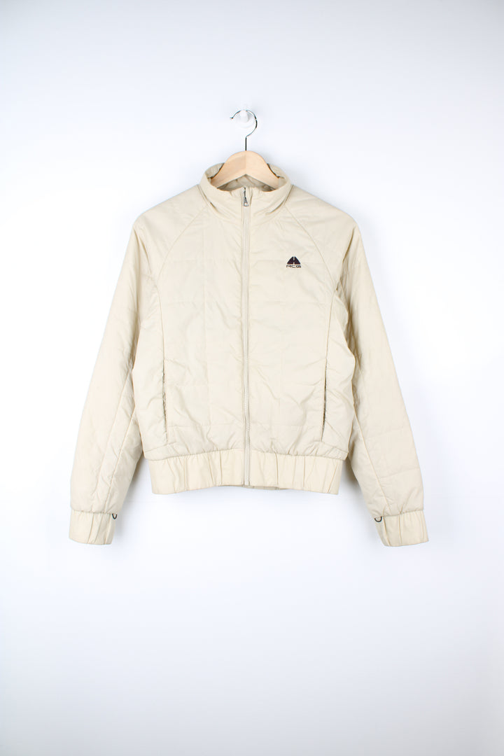 Cream Nike ACG thermal layer lightly padded zip through jacket, features embroidered logo on the chest