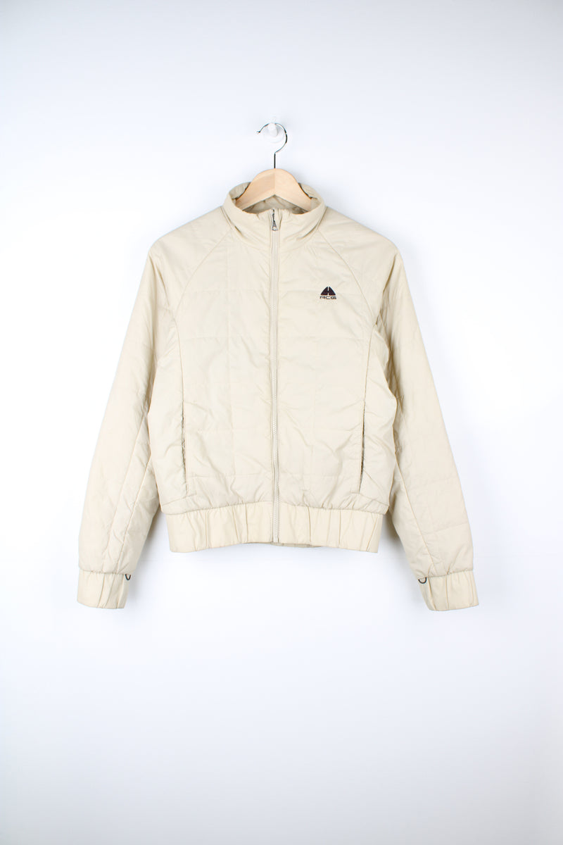 Cream Nike ACG thermal layer lightly padded zip through jacket, features embroidered logo on the chest