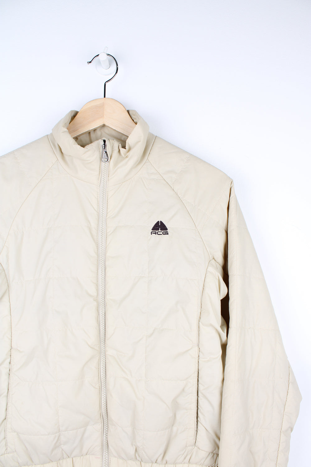 Cream Nike ACG thermal layer lightly padded zip through jacket, features embroidered logo on the chest