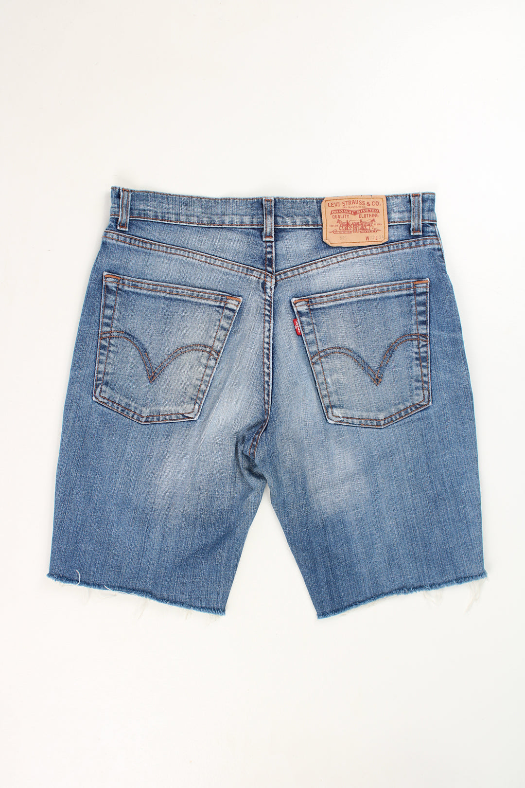 Levi's 525 blue denim jorts with embroidered details on the back pockets and frayed legs