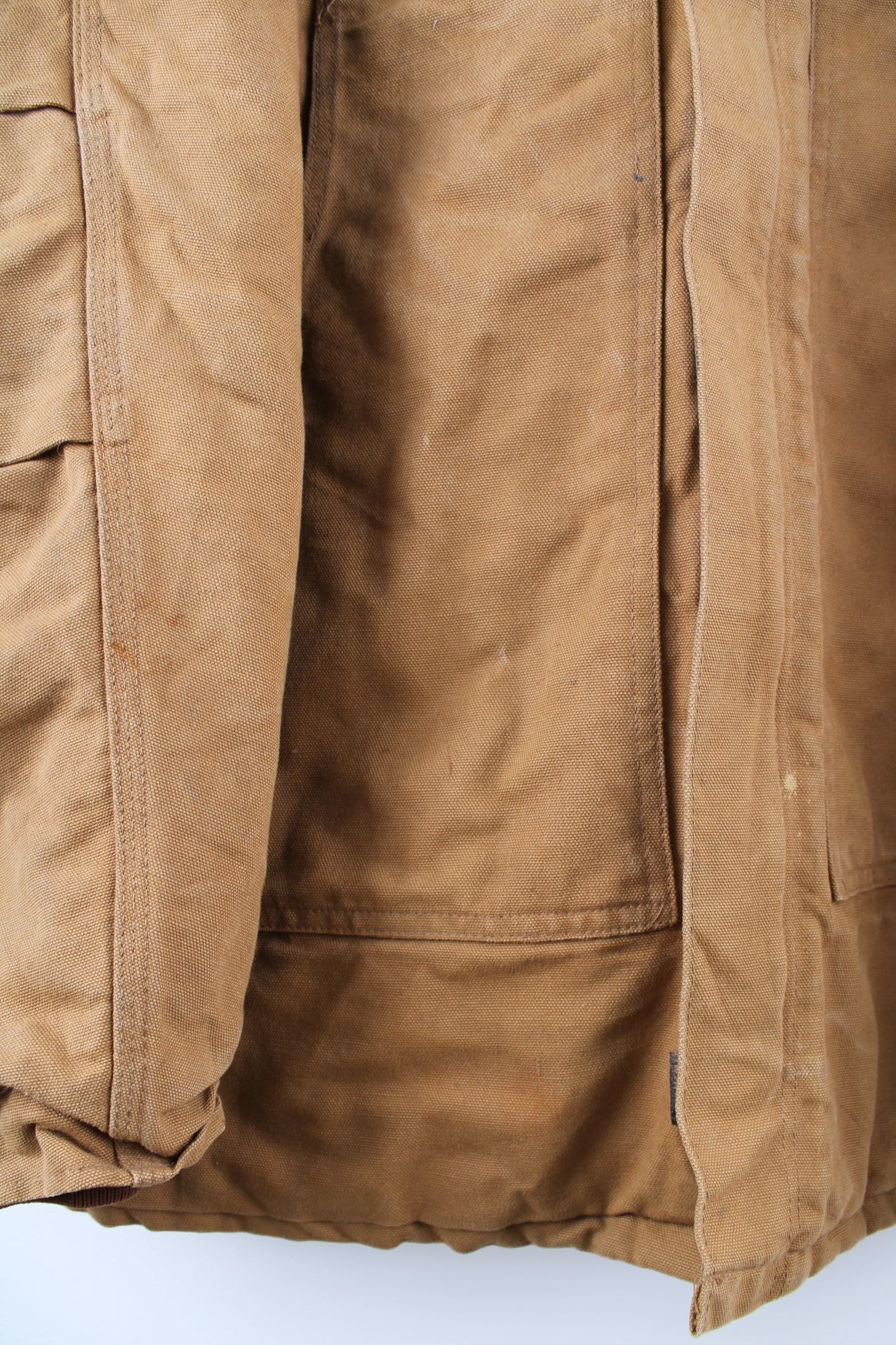 Carhartt Arctic Jacket in a tanned colourway with a brown corduroy collar, zip up, multiple pockets, and has the logo embroidered on the front.